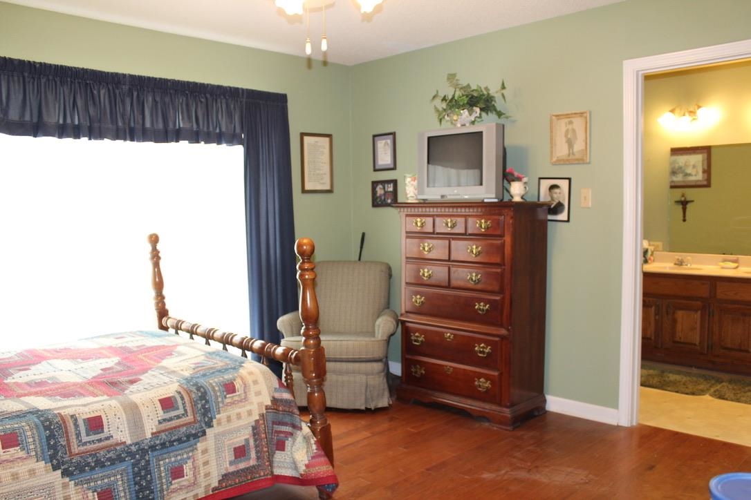954 New Hope Road Ripley, TN 38063 - Photo 14 of 35 a bedroom with a bed and a dresser