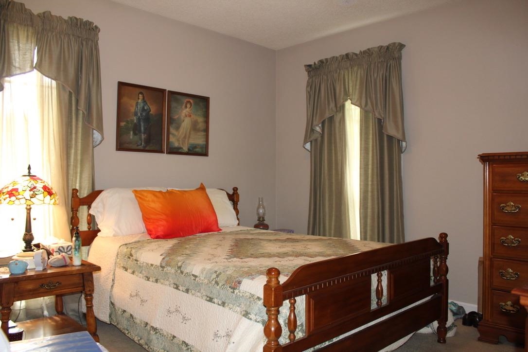 954 New Hope Road Ripley, TN 38063 - Photo 20 of 35 a bedroom with a bed and a lamp on dresser