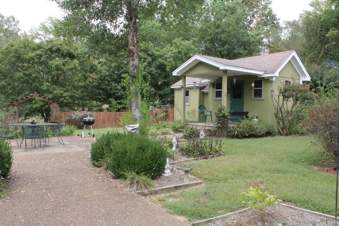 954 New Hope Road Ripley, TN 38063 - Photo 24 of 35 a front view of a house with a yard and lake view