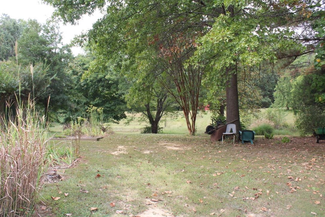 954 New Hope Road Ripley, TN 38063 - Photo 28 of 35 a backyard of a house with table and chairs