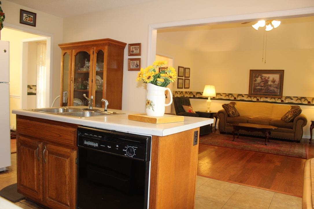 954 New Hope Road Ripley, TN 38063 - Photo 6 of 35 a kitchen with a sink and a refrigerator
