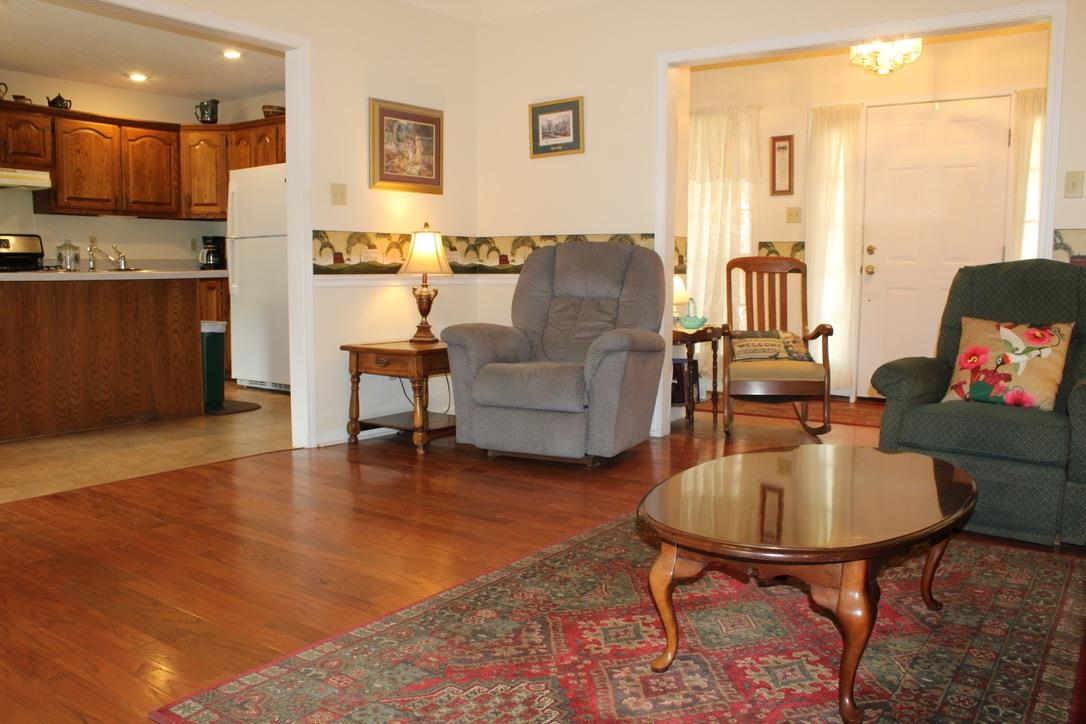 954 New Hope Road Ripley, TN 38063 - Photo 8 of 35 a living room with furniture and a dining table with wooden floor