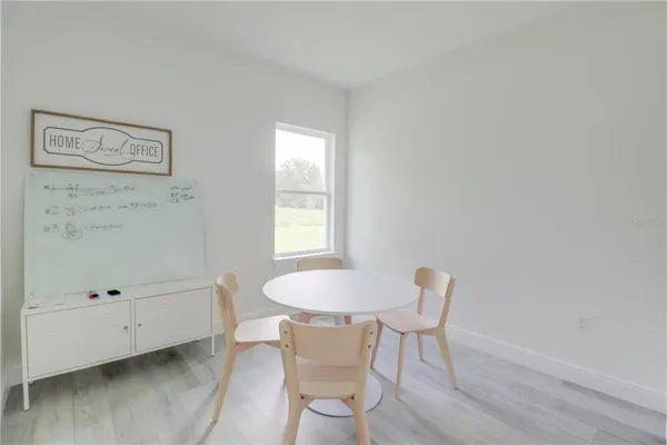 a dining room with furniture and window