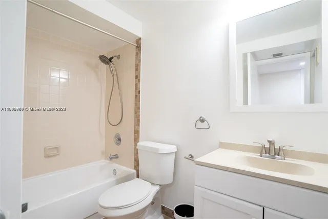 a bathroom with a sink toilet vanity and shower