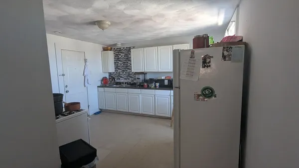 a kitchen with stainless steel appliances a refrigerator and a stove
