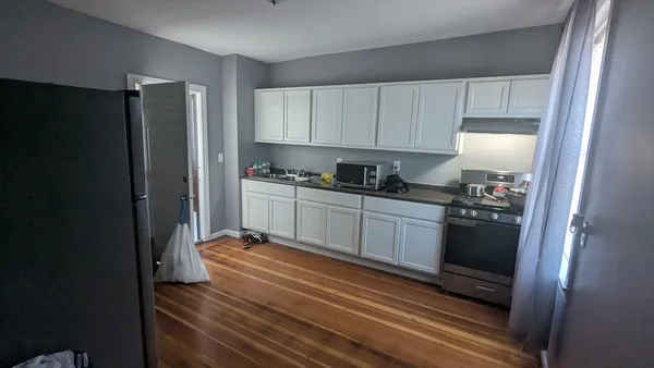 a kitchen with a refrigerator and cabinets