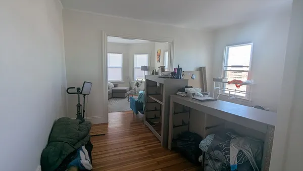 a living room with furniture a flat screen tv and a window