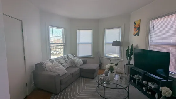 a dining room with furniture and wooden floor