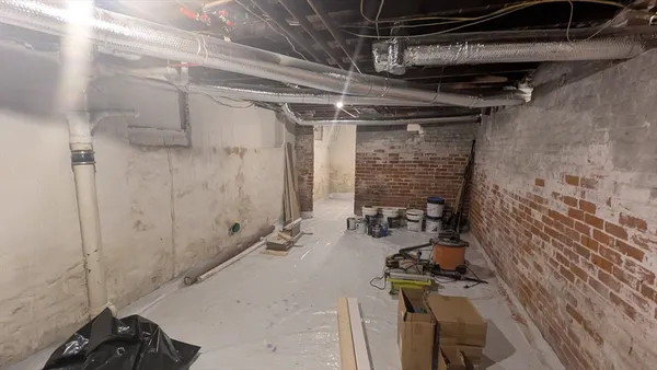 a view of a hallway with wooden floor and closet