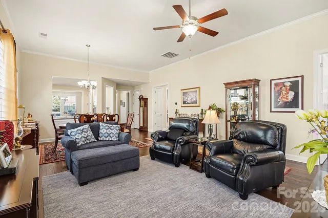 a living room with furniture ceiling fan and a rug