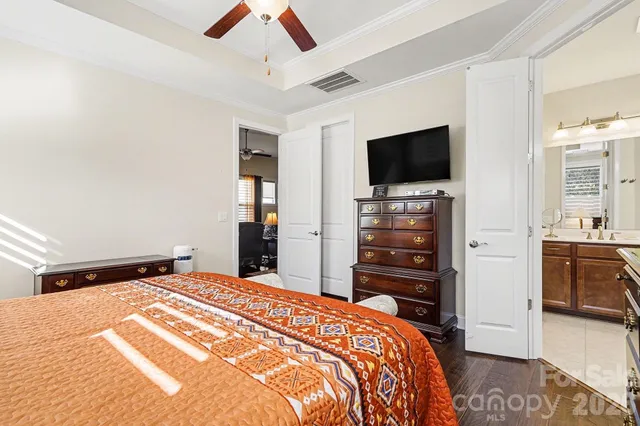 a bedroom with a bed and flat screen tv