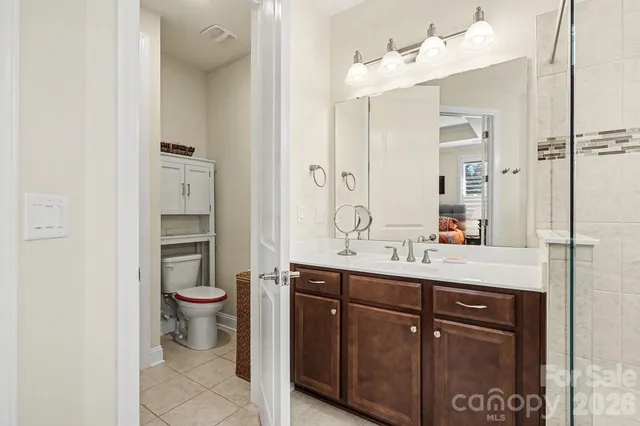 a bathroom with a toilet sink and mirror
