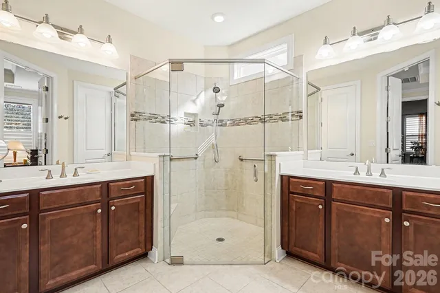 a bathroom with a shower sink and mirror