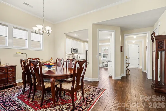 a view of a a dining room with furniture window and wooden floor