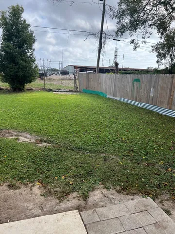 a view of a swimming pool with a yard