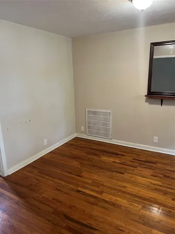 a view of room with wooden floor and fan