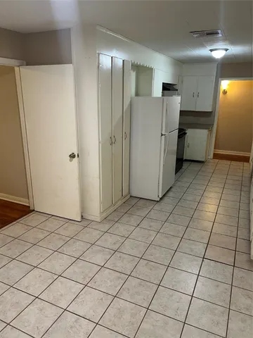 a view of a refrigerator and utility room in a kitchen