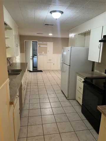 a kitchen with stainless steel appliances granite countertop a refrigerator and a stove