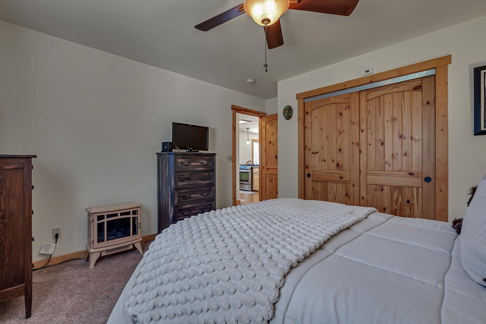 29101 Day Road McArthur, CA 96056 - Photo 28 of 48 a spacious bedroom with a bed and a flat tv screen on dresser