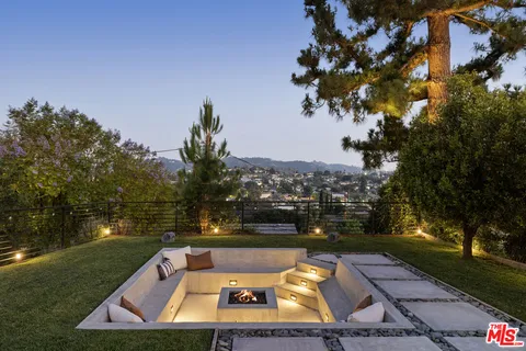 a view of a back yard of the house and trees