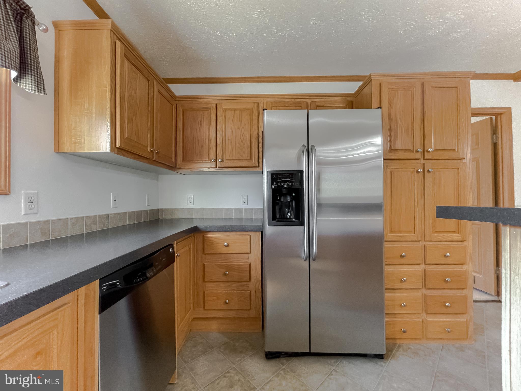 21221 Colton Point Road Avenue, MD 20609 - Photo 31 of 39 Side-by-side fridge with door dispenser
