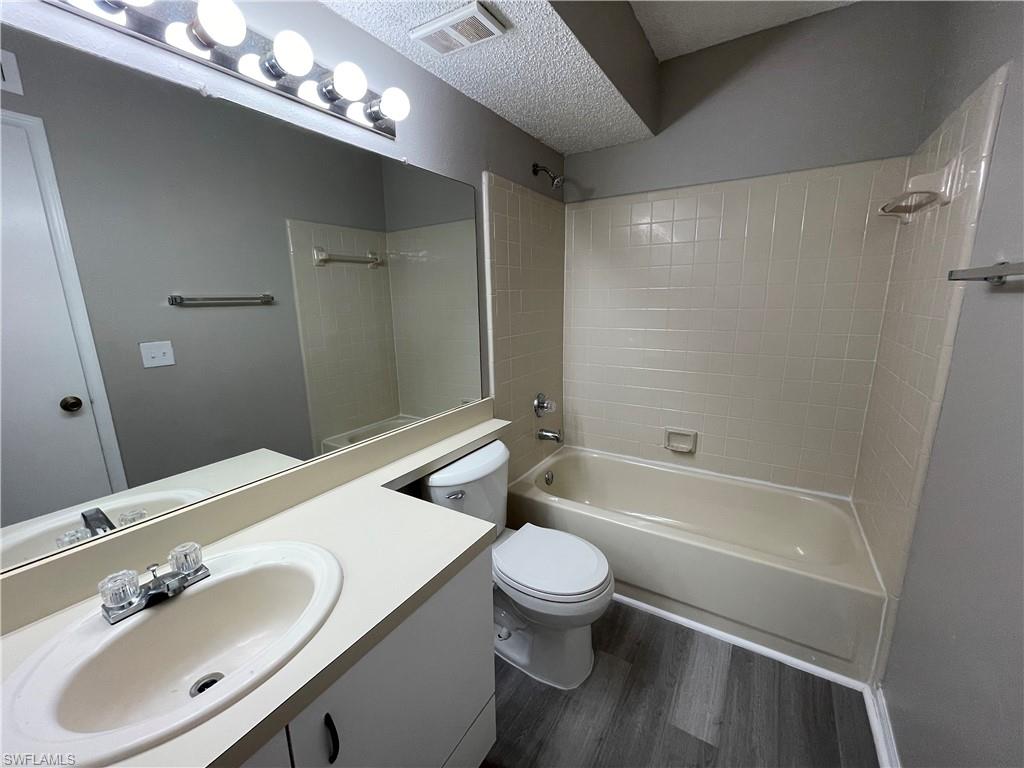 13555 Eagle Ridge Drive, Unit 925 Fort Myers, FL 33912 - Photo 8 of 15 a bathroom with a sink vanity granite toilet tub and shower