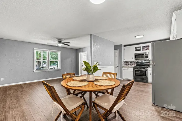 a view of a dining room with furniture and wooden floor