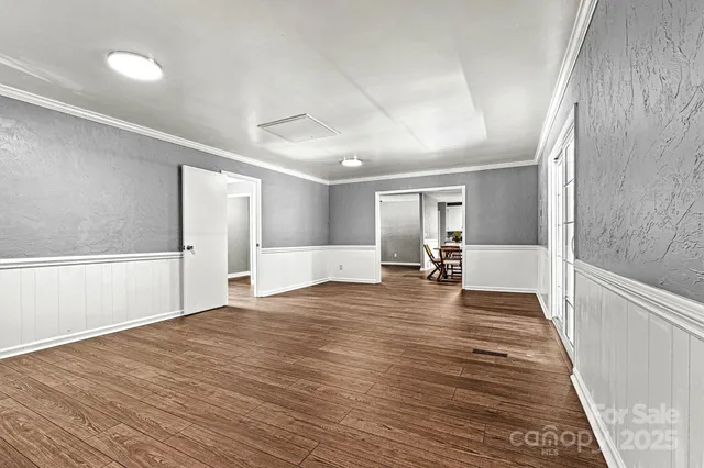 a view of a livingroom with wooden floor and a large window