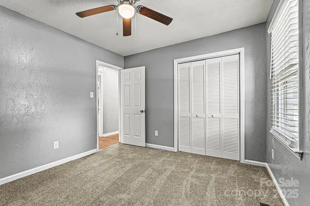 an empty room with windows and closet