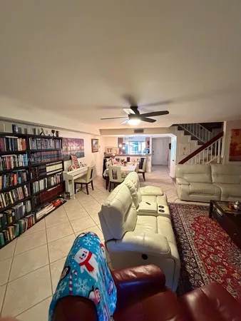 a living room with furniture and a book shelf