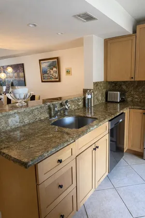 a kitchen with stainless steel appliances granite countertop a sink and cabinets