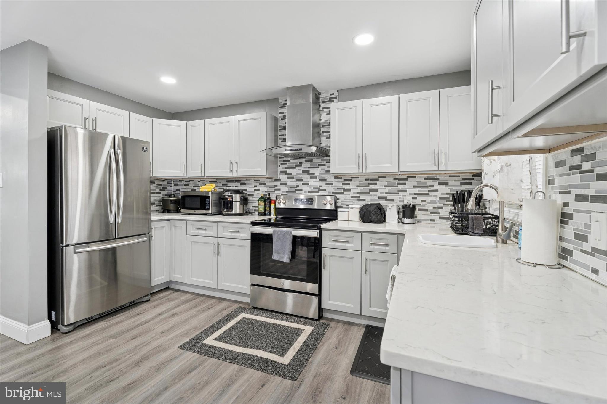 8319 Woolston Avenue Philadelphia, PA 19150 - Photo 3 of 30 a kitchen with a white cabinets and white appliances
