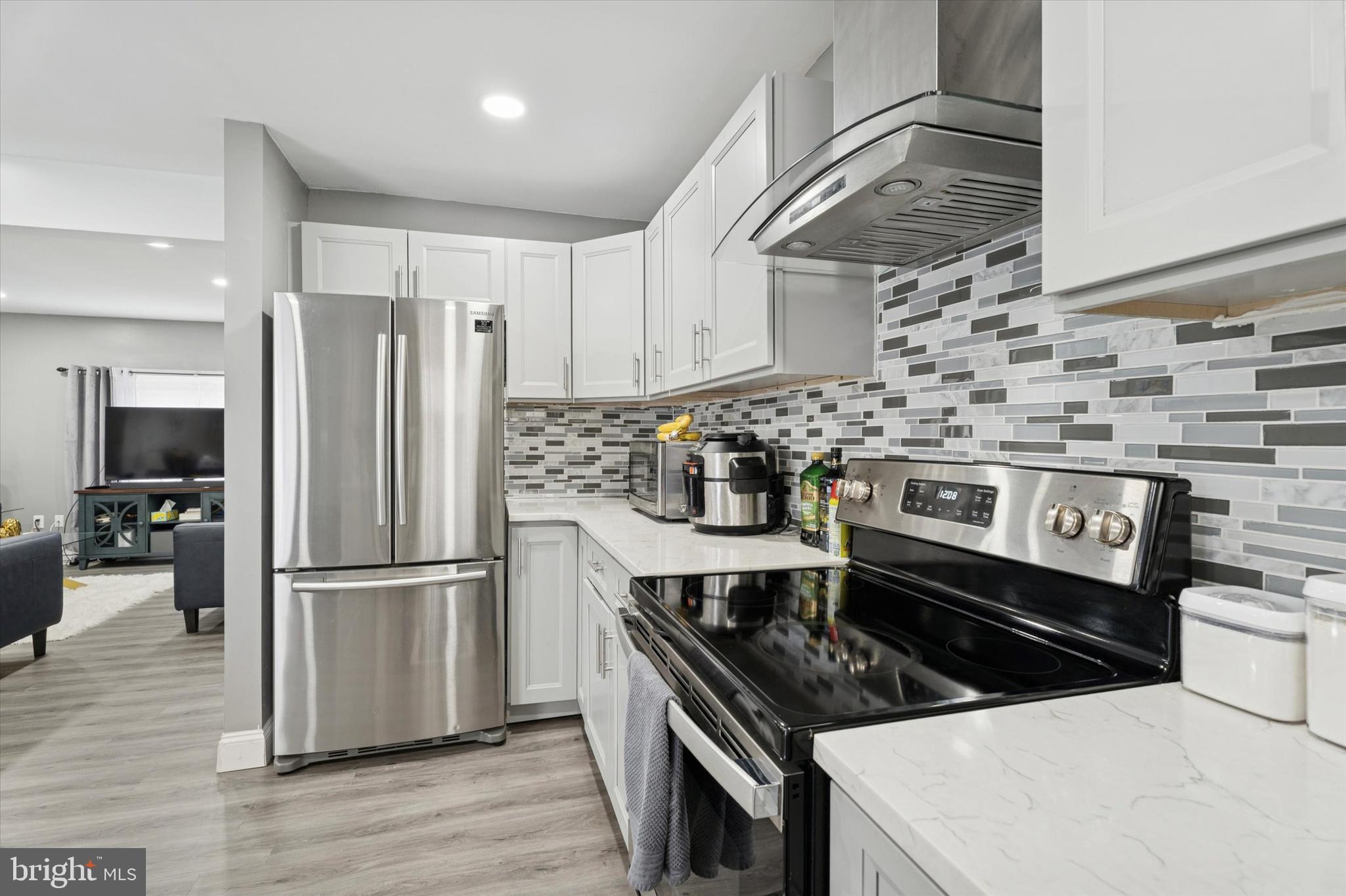 8319 Woolston Avenue Philadelphia, PA 19150 - Photo 5 of 30 a kitchen with a stove and a refrigerator