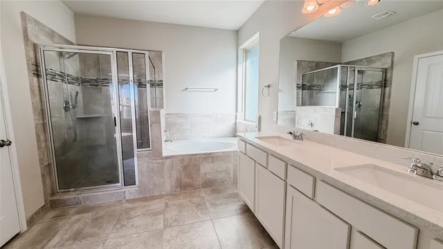 a spacious bathroom with a shower sink and mirror