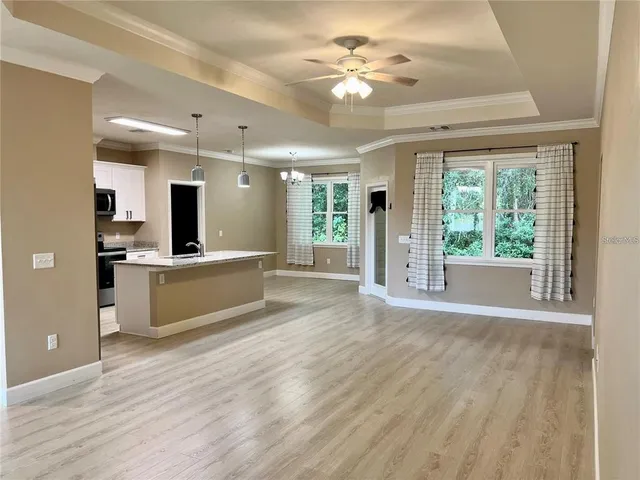 a view of kitchen with sink and wooden floor