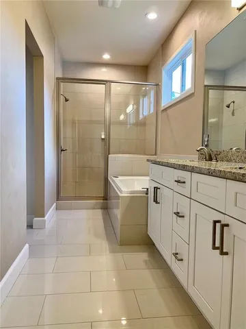a bathroom with a granite countertop sink a toilet and shower