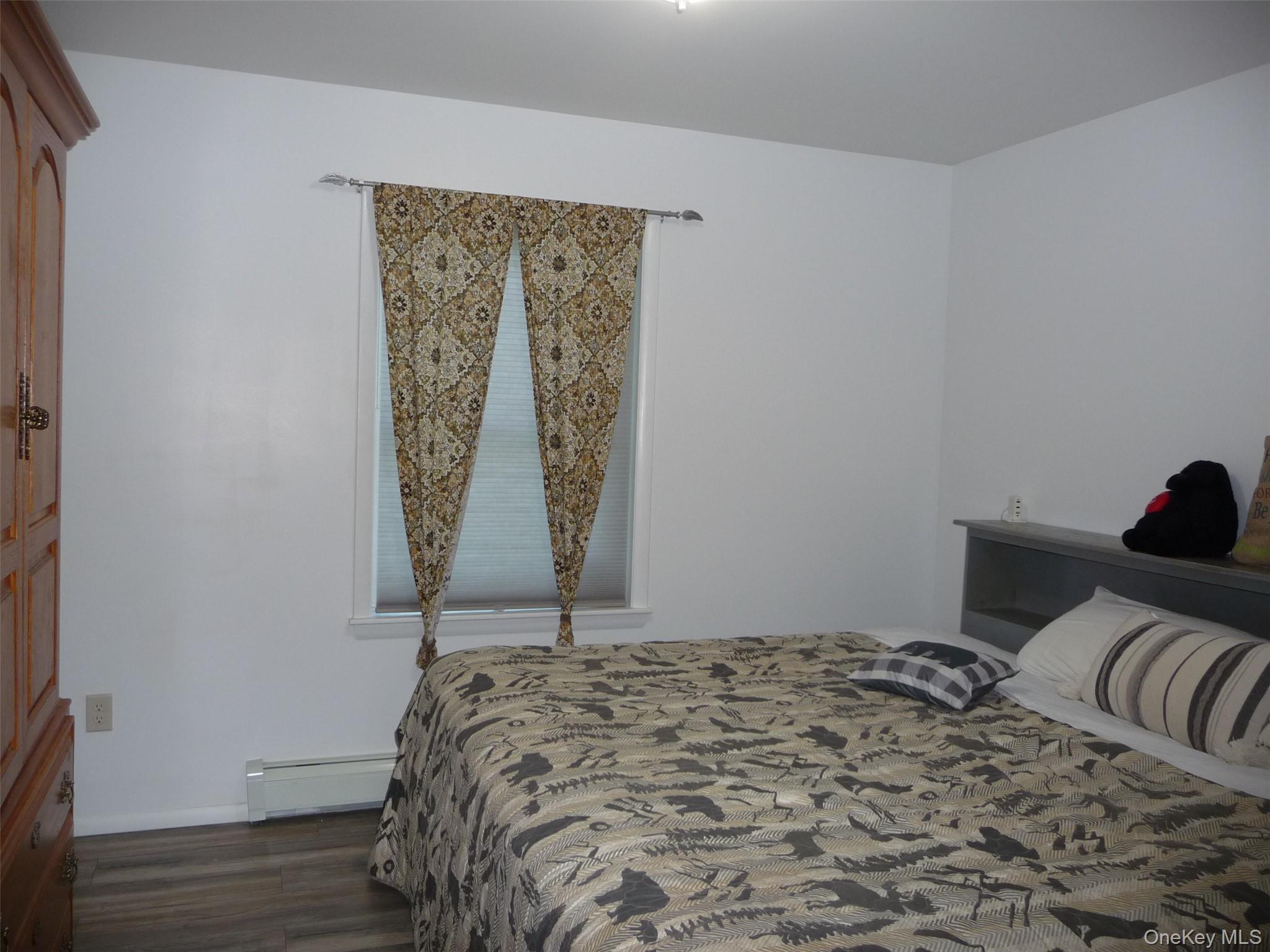 173 Franke Road Huguenot, NY 12746 - Photo 11 of 39 a bed sitting in a bedroom next to a window