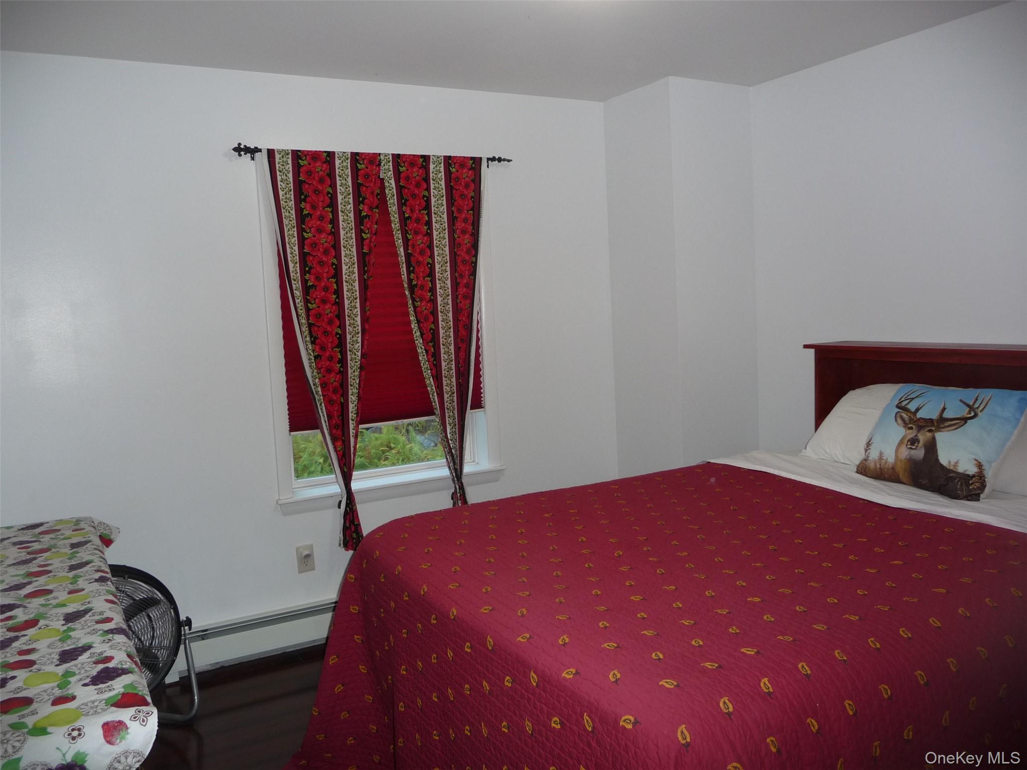 173 Franke Road Huguenot, NY 12746 - Photo 13 of 39 a bedroom with a bed and a window