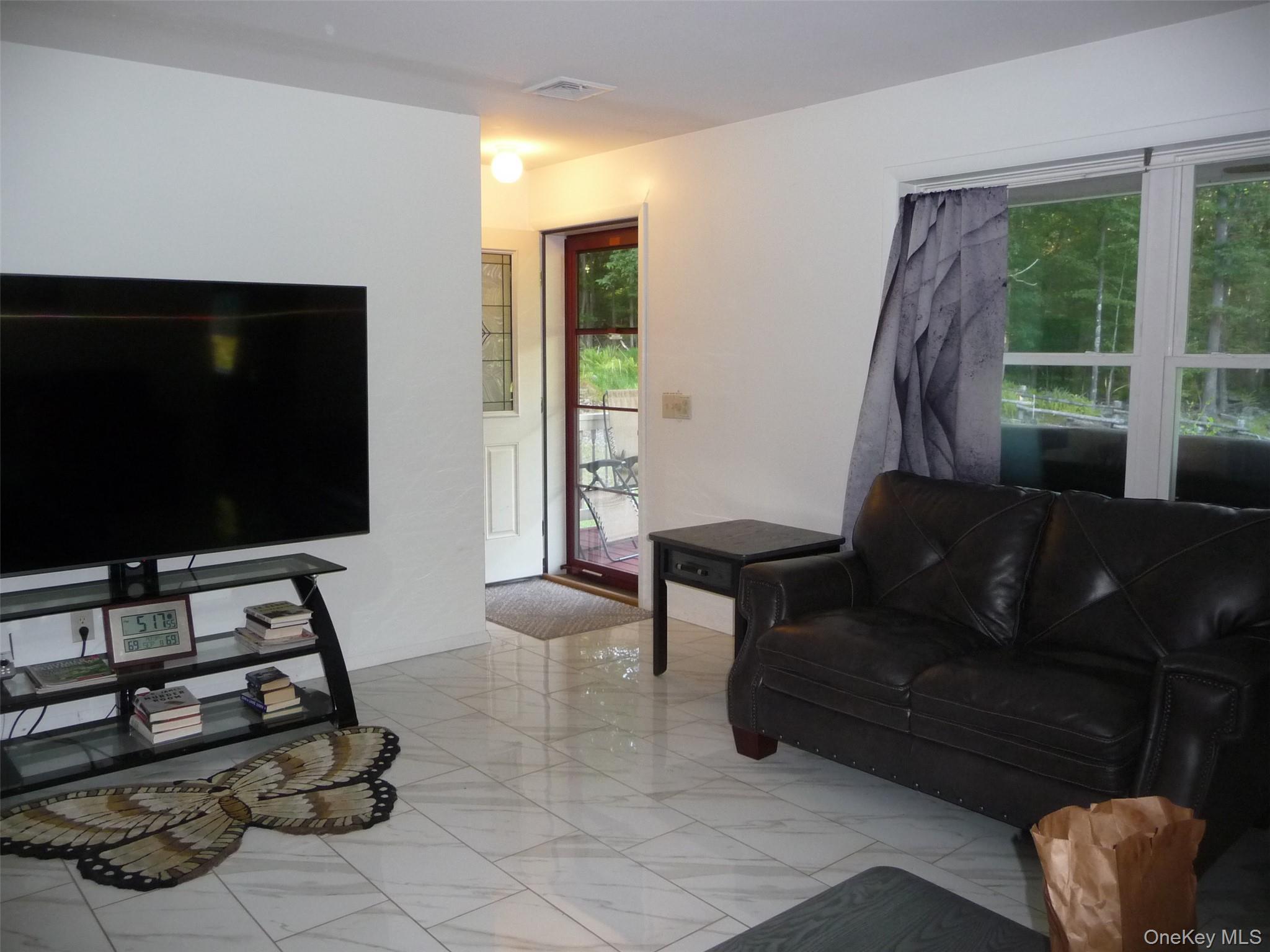 173 Franke Road Huguenot, NY 12746 - Photo 4 of 39 a living room with furniture and a flat screen tv