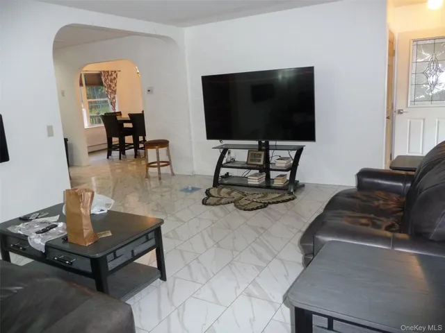 a view of a dining room with furniture a chandelier and wooden floor