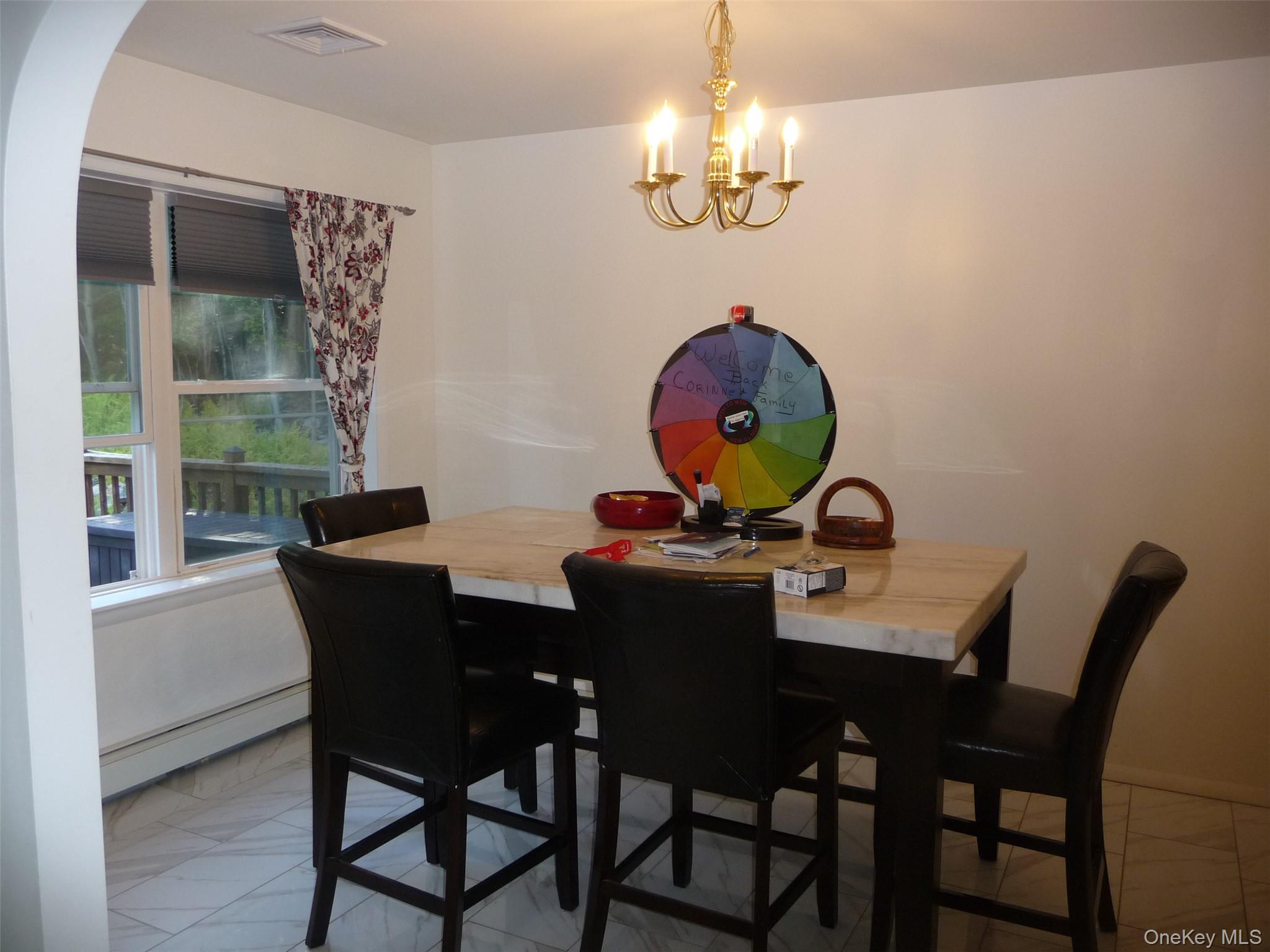 173 Franke Road Huguenot, NY 12746 - Photo 7 of 39 a view of a dining room with furniture a chandelier and wooden floor