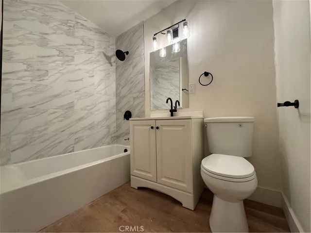 a big room with wooden floor and windows