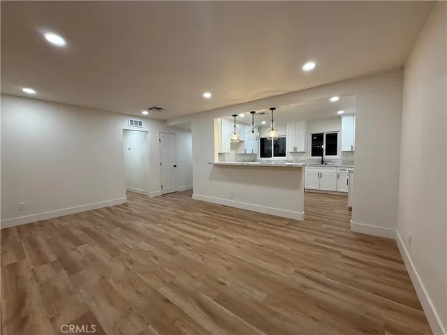 a large kitchen with kitchen island a sink stainless steel appliances and cabinets