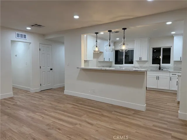 a kitchen with wooden cabinets sink and granite counter top