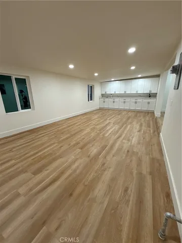 an empty room with ceiling fan and window