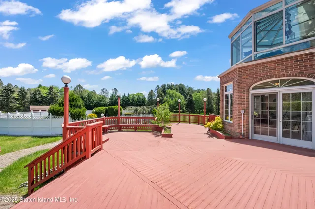 a view of a house with swimming pool and sitting area