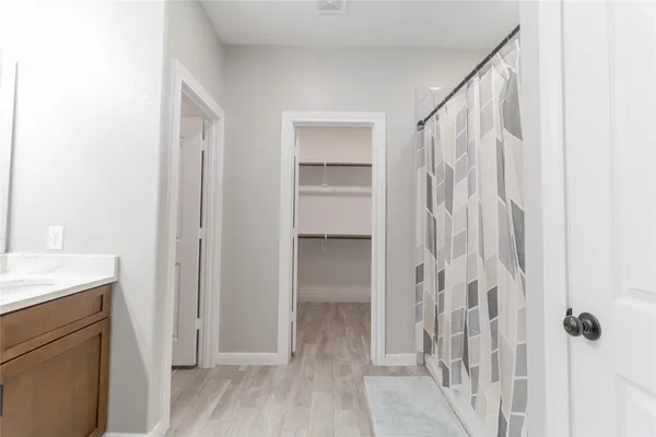 a bathroom with a shower and a sink