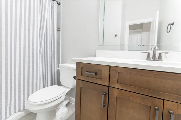 a bathroom with a sink toilet and mirror