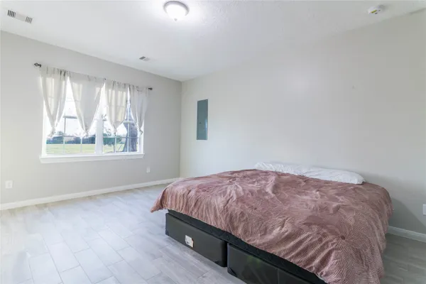 a bedroom with a bed and a window