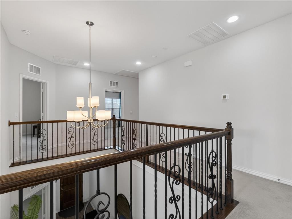 636 Corner Post Path Celina, TX 75009 - Photo 25 of 40 Open landing featuring a decorative wrought iron and wood-finish railing